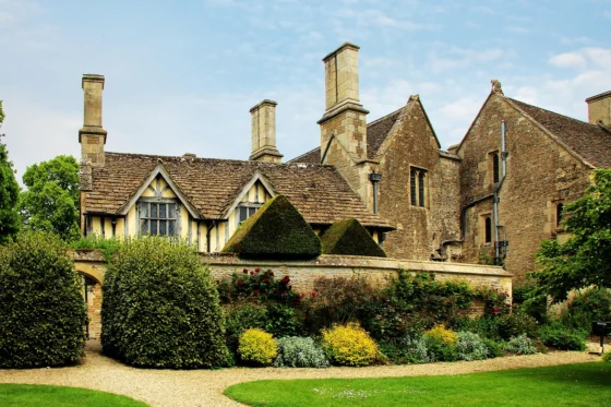 Comparison of a historical Victorian home and a modern glass mansion side by side