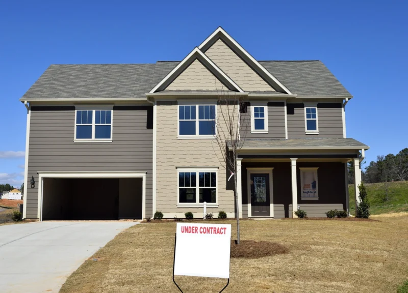 New construction vs custom home - luxury home under construction with workers and framing