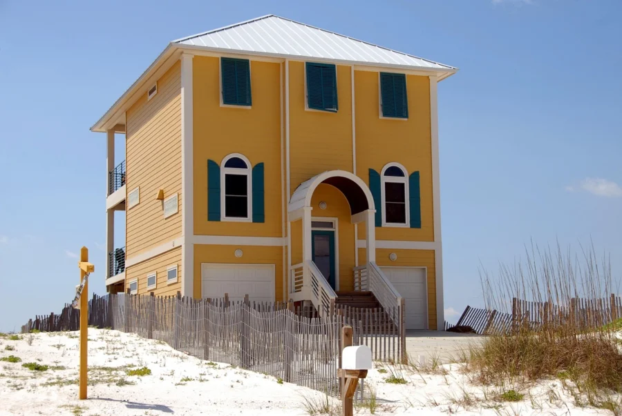 Luxury beach house exterior on the coast, illustrating a vacation home vs primary luxury property
